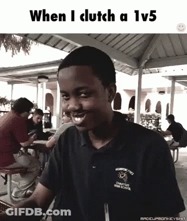 A Young Man Is Smiling While Sitting At A Picnic Table In Front Of A Group Of People . GIF