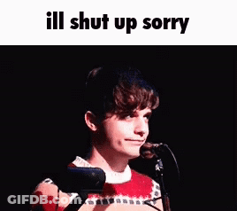 A Young Man Is Standing In Front Of A Microphone With The Words `` Ill Shut Up Sorry '' Written Above Him . GIF