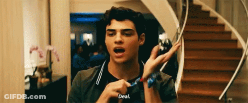 A Young Man Is Standing In Front Of A Set Of Stairs Holding A Scarf Around His Wrist . GIF