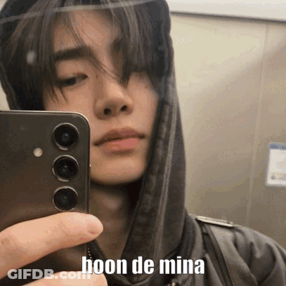 A Young Man Is Taking A Selfie With His Cell Phone . GIF