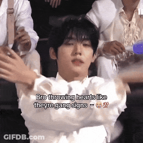 A Young Man Is Throwing Hearts Like Theyre Gang Signs GIF