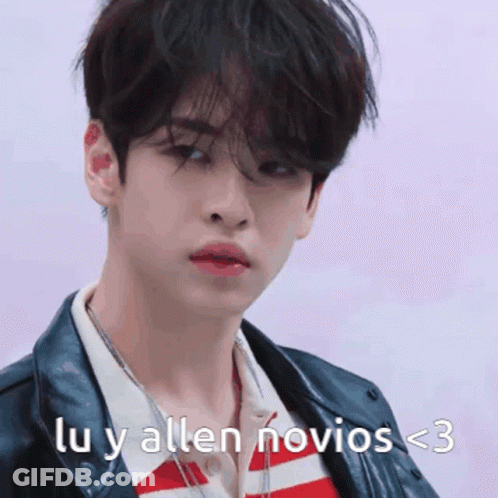 A Young Man Is Wearing A Leather Jacket And A Striped Shirt With The Words Lu Y Allen Novios < 3 On The Bottom GIF