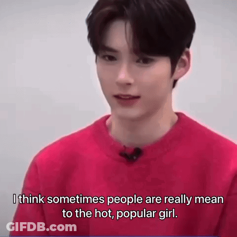 A Young Man Is Wearing A Red Sweater And Talking To A Camera . GIF