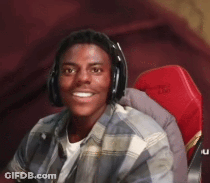 A Young Man Is Wearing Headphones And Smiling While Sitting In A Red Chair . GIF