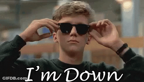 A Young Man Is Wearing Sunglasses And The Words `` I 'M Down '' Are Written On The Screen Behind Him . GIF