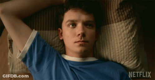 A Young Man Laying On A Bed With Netflix Written On The Bottom GIF