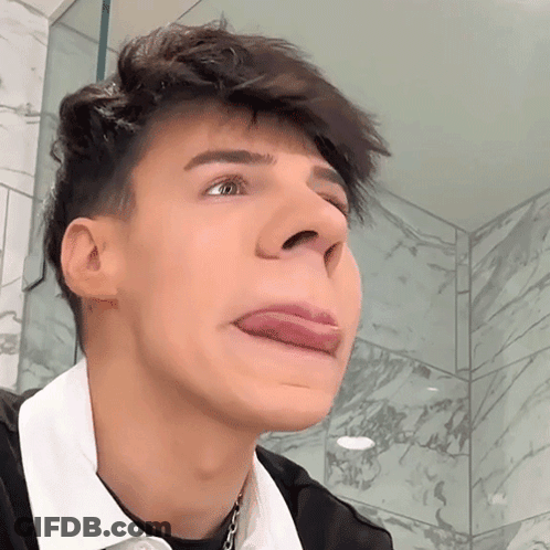 A Young Man Making A Face With His Tongue Out GIF