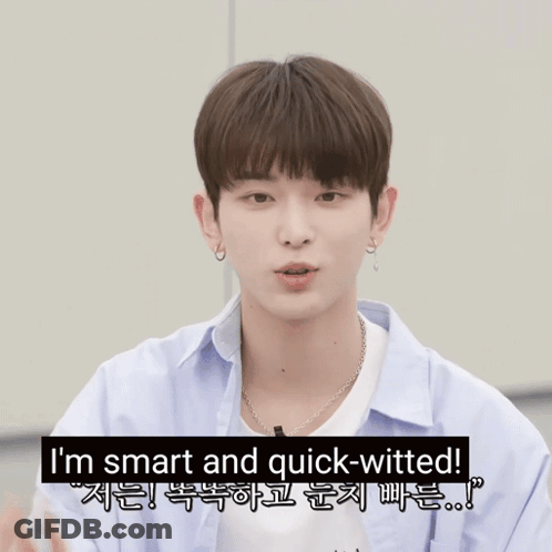 A Young Man Pointing At The Camera With The Words I 'M Smart And Quick-Witted Behind Him GIF