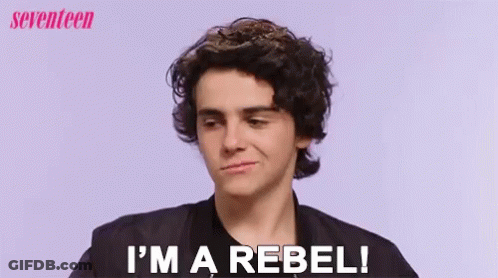 A Young Man Says I 'M A Rebel In Front Of A Purple Background GIF