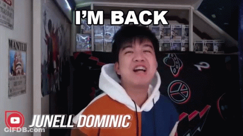 A Young Man Says I 'M Back While Standing In Front Of A Wanted Poster GIF