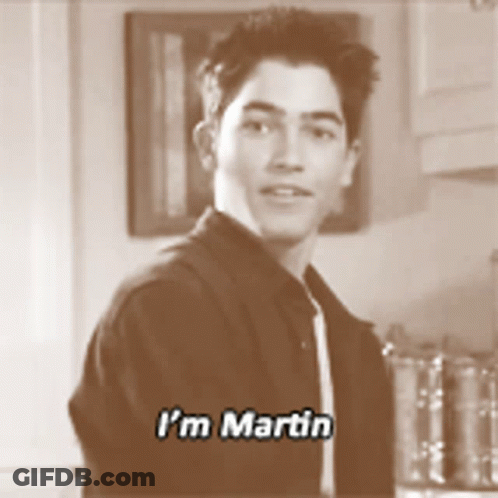 A Young Man Says I 'M Martin While Standing In A Kitchen GIF
