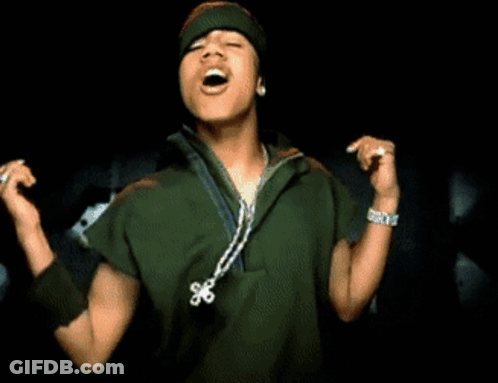 A Young Man Singing Into A Microphone Wearing A Green Jacket And A Beanie GIF