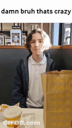 A Young Man Sits At A Table With A Mcdonald 'S Bag And A Cup GIF