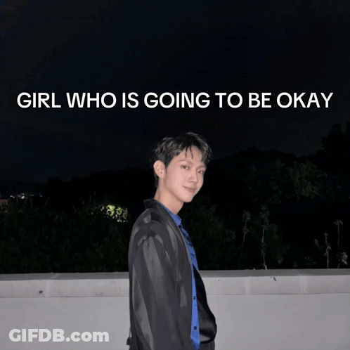 A Young Man Stands In Front Of A Poster That Says Girl Who Is Going To Be Okay GIF