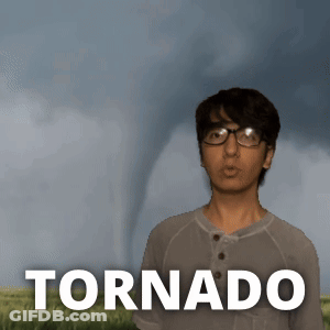 A Young Man Stands In Front Of A Tornado GIF