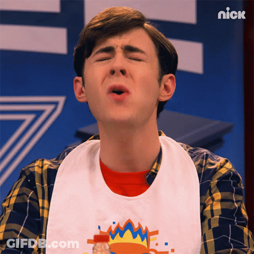A Young Man Wearing A Bib With The Word Nick On The Bottom GIF