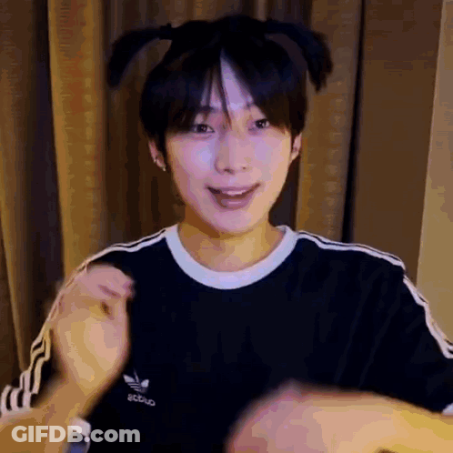 A Young Man Wearing A Black Adidas T-Shirt Is Making A Funny Face . GIF