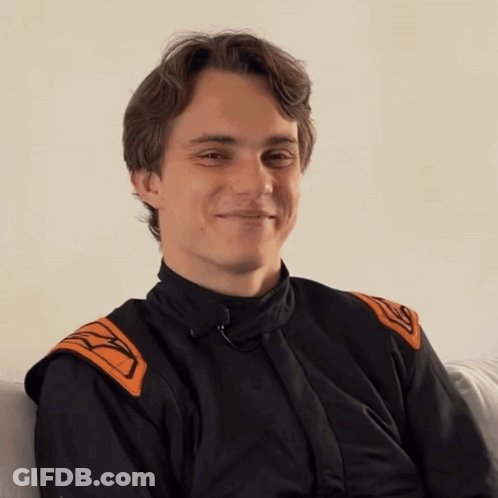 A Young Man Wearing A Black And Orange Jacket With The Letter K On The Sleeves GIF