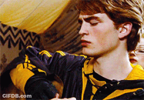 A Young Man Wearing A Black And Yellow Striped Shirt With The Letter H On It GIF