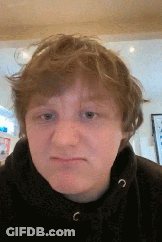 A Young Man Wearing A Black Hoodie With The Letter C On The Front Of It GIF