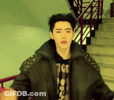 A Young Man Wearing A Black Jacket And A T-Shirt That Says Tcg GIF
