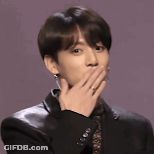 A Young Man Wearing A Black Jacket And Earrings Is Clapping His Hands GIF
