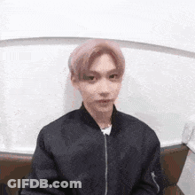 Young Man In Black Jacket Sitting On Couch GIF