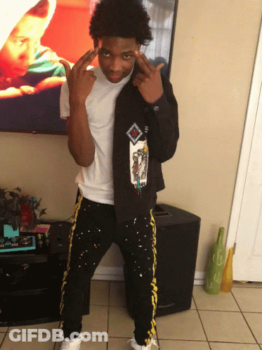 A Young Man Wearing A Black Jacket With A Picture Of A Baby On It GIF