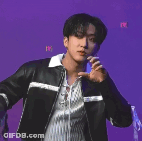 A Young Man Wearing A Black Leather Jacket And A White Shirt Is Dancing On A Purple Background . GIF
