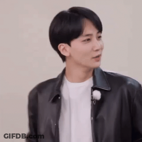 A Young Man Wearing A Black Leather Jacket And A White T-Shirt . GIF