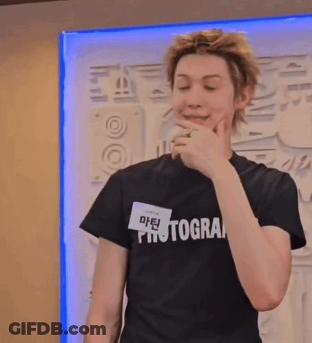 A Young Man Wearing A Black Photographer T-Shirt GIF