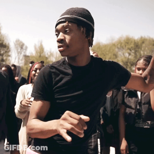 A Young Man Wearing A Black Shirt And A Beanie With The Word Reebok On It GIF