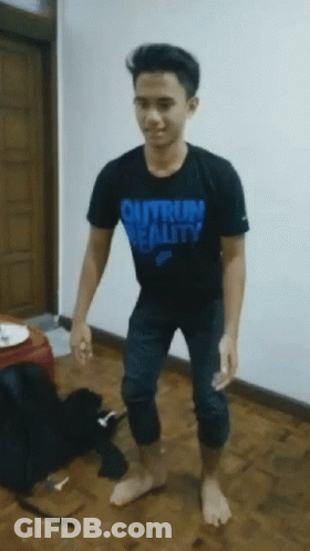 A Young Man Wearing A Black Shirt That Says " Outrun Reality " GIF