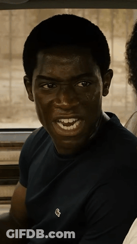 A Young Man Wearing A Black Shirt With A White Lacoste Logo GIF
