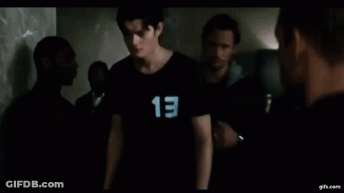 A Young Man Wearing A Black Shirt With The Number 13 On It . GIF