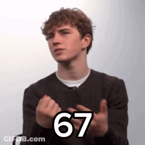 A Young Man Wearing A Black Sweater And A White Shirt Shows The Number 67 GIF