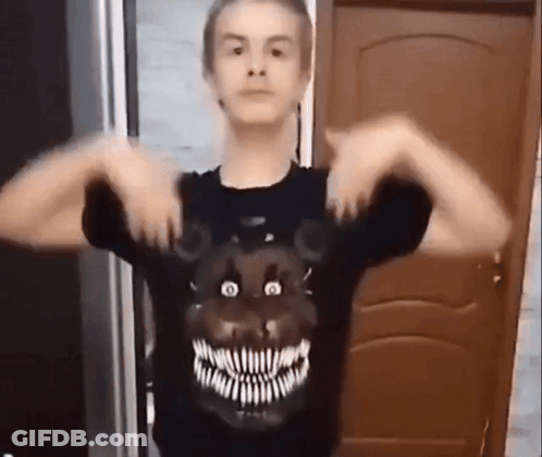 A Young Man Wearing A Black T-Shirt With A Teddy Bear Face On It . GIF