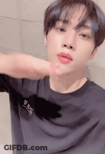 A Young Man Wearing A Black T-Shirt With Chinese Characters On The Front GIF