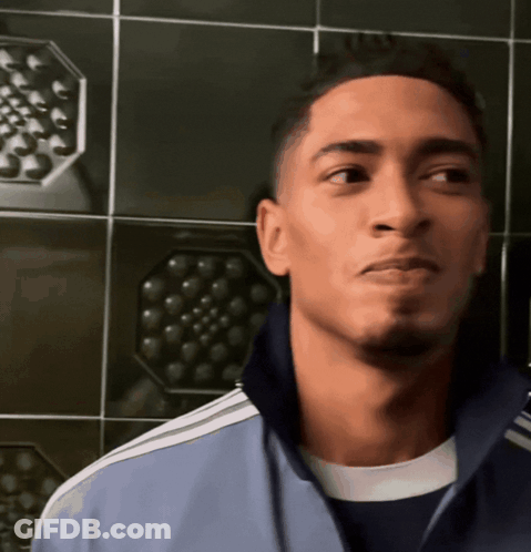 A Young Man Wearing A Blue Adidas Jacket Looks To His Left GIF