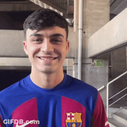 A Young Man Wearing A Blue And Red Fcb Shirt Smiles GIF