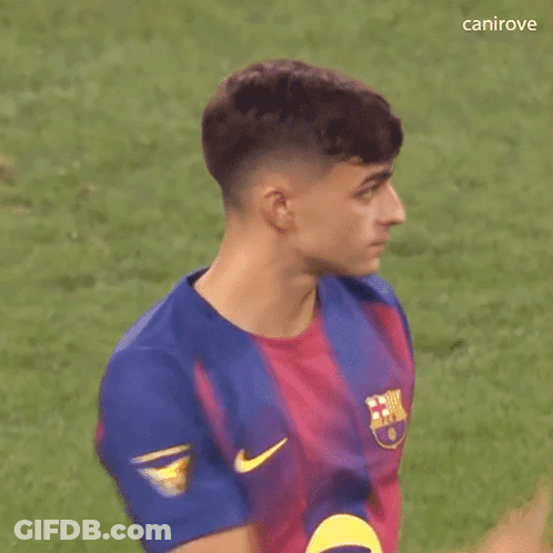 A Young Man Wearing A Blue And Red Nike Jersey Is Standing On A Field . GIF