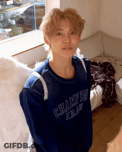 A Young Man Wearing A Blue Champion Sweater GIF