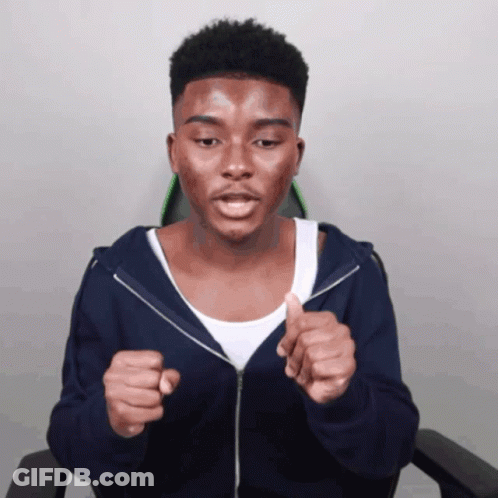 A Young Man Wearing A Blue Hoodie And A White Tank Top Is Giving A Thumbs Up GIF