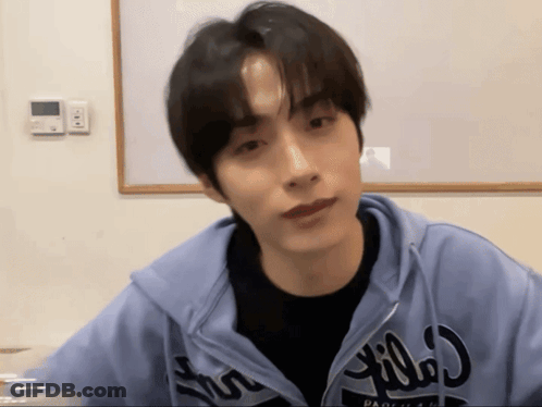 A Young Man Wearing A Blue Hoodie That Says ' Pacifica ' On It GIF