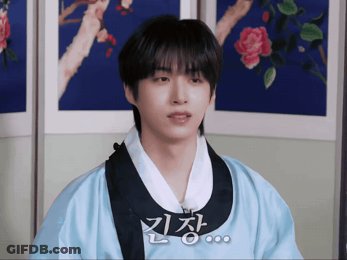 A Young Man Wearing A Blue Kimono With Chinese Writing On The Front GIF