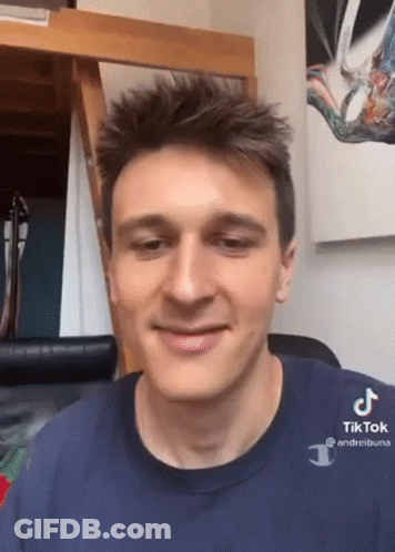 A Young Man Wearing A Blue Shirt That Says Tik Tok GIF