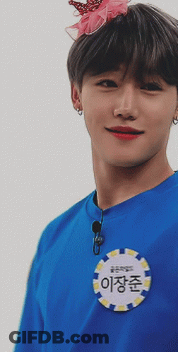 A Young Man Wearing A Blue Shirt With A Name Tag That Says ' 이장준 ' GIF