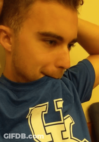 A Young Man Wearing A Blue Shirt With The Letter G On The Front GIF