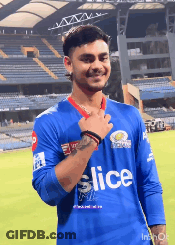 A Young Man Wearing A Blue Slice Jersey Stands On A Field GIF