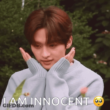A Young Man Wearing A Blue Sweater Is Making A Sad Face And Says I Am Innocent GIF